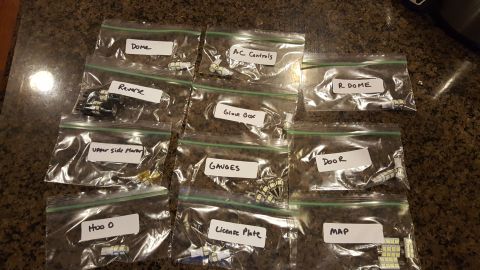 1996 Ford Bronco - Eleven zip-top bags of replacement LED bulbs laid out on a granite countertop, each labeled by hand for its location: Dome, A/C Controls, R…