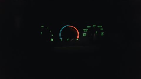 1996 Ford Bronco - The climate control panel displays glowing green text and a temperature dial with red and blue indicators.