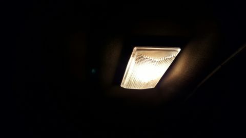 1996 Ford Bronco - Illuminated interior dome light in a dark vehicle cabin.