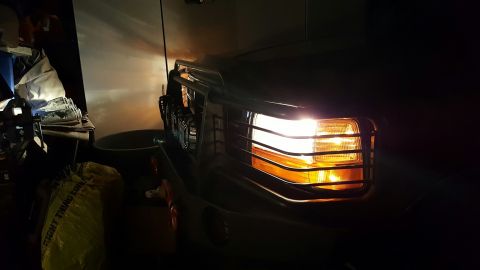 1996 Ford Bronco - Close-up of a 1992 Ford Bronco's front grille and illuminated headlights.