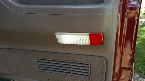 1996 Ford Bronco - Close-up of a vehicle's interior door panel showing a light and air vent.