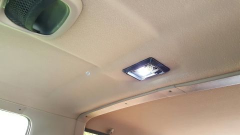 1996 Ford Bronco - Interior view of a vehicle's ceiling, showing overhead lights and a speaker grille.