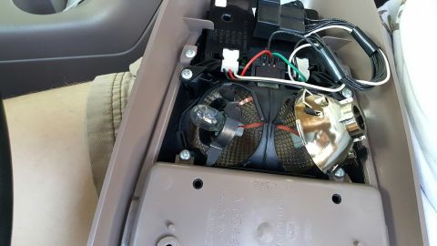 1996 Ford Bronco - Close-up view of an interior light assembly, showing the bulb, reflector, and wiring harness.