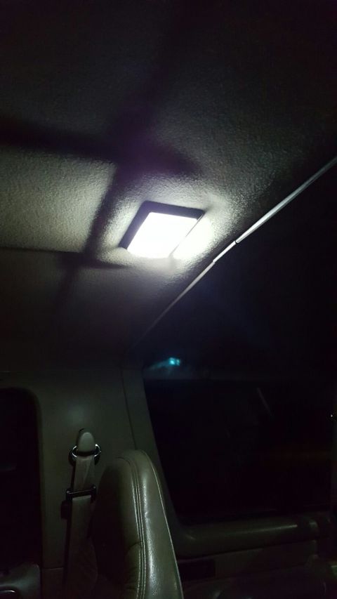1996 Ford Bronco - The interior of a vehicle is shown, focusing on the overhead light and a portion of the seating.