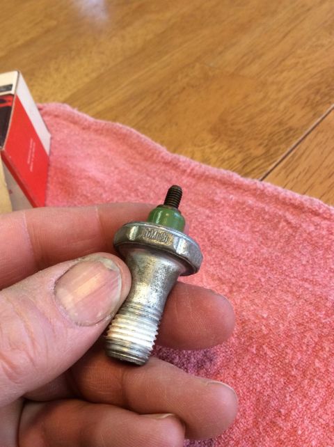 1968 Ford Mustang - Close-up of an oil pressure sending unit being held in a hand.