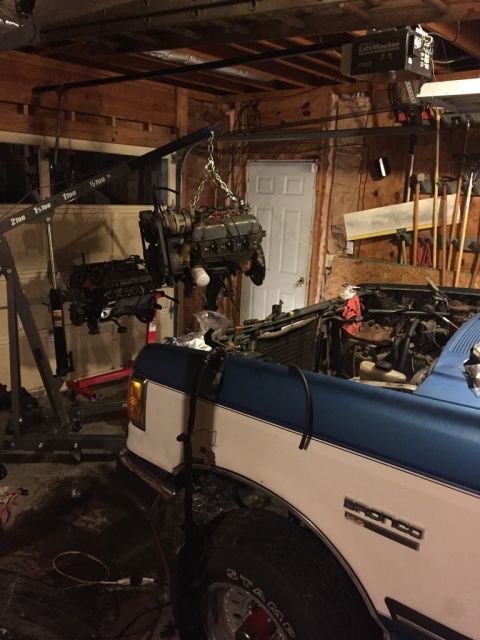 1989 Ford Bronco - here you see the bronco, the old motor on the hoist, and the new (used) motor on the stand at the back.