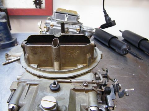 1967 Mercury Cougar - Close-up view of automotive parts including carburetors and shock absorbers.