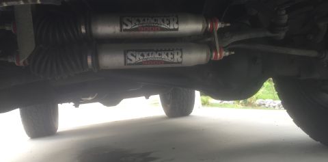 1995 Ford Bronco - Vehicle undercarriage with Skyjacker shocks and suspension parts visible.