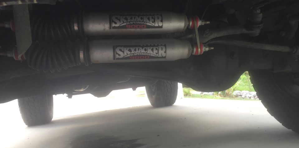 Underbody view showing two Skyjacker shocks and suspension components