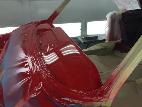 1964 Ford Fairlane - The interior of a car is being painted red, with protective tape applied to various surfaces.