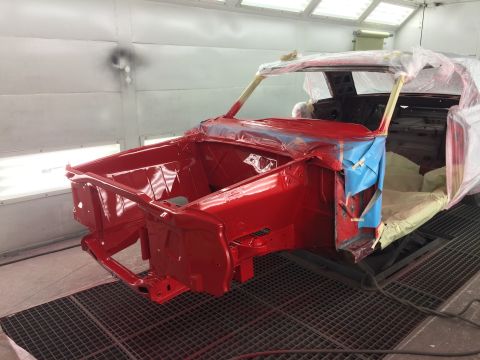 1964 Ford Fairlane - A 1964 Ford Fairlane body is being prepped for paint in a spray booth, showing its front quarter section.