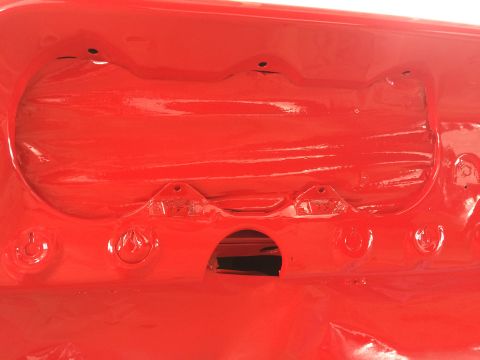 1964 Ford Fairlane - Close-up of a red automotive component, showing mounting points and a central aperture.
