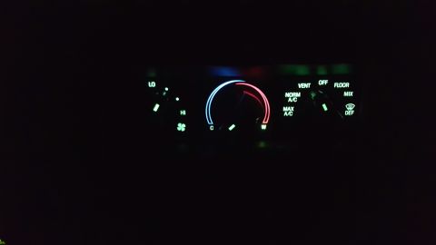 1996 Ford Bronco - The illuminated dashboard controls display fan speed, temperature, and air distribution settings in the dark.