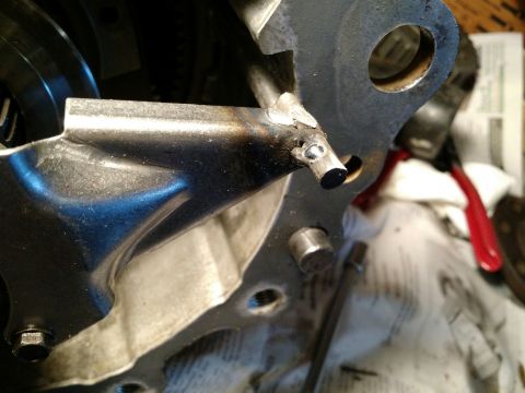 1992 Ford Bronco - This image shows a close-up of a metal bracket with a welded pin, likely a component of a transfer case.