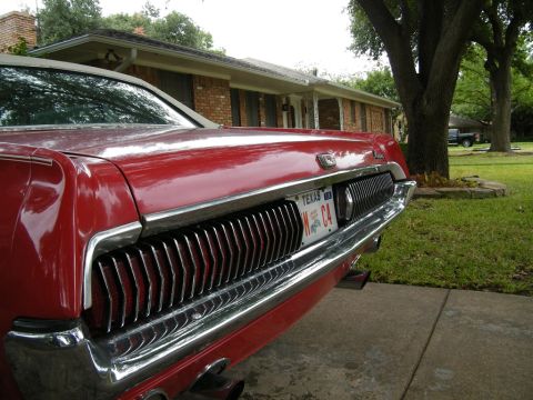 1968 Mercury Cougar - The rear of a red 1968 Mercury Cougar is shown, its distinctive grille and Texas license plate.