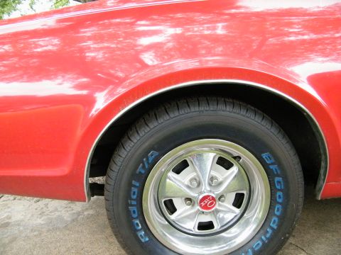 1968 Mercury Cougar - Close-up of the rear wheel and fender of a red 1968 Mercury Cougar.