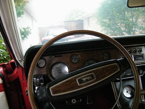 1968 Mercury Cougar - Interior view of a 1968 Mercury Cougar, showing the dashboard and steering wheel, with another car visible through the windshield.