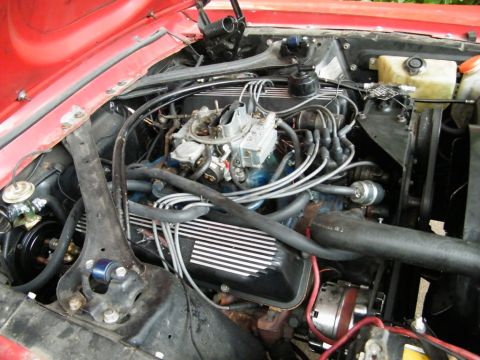 1968 Mercury Cougar - Close-up view of a V8 engine bay, showing the carburetor and wiring.