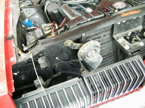 1968 Mercury Cougar - Close-up view of the front of a car's engine compartment, including the radiator and horn assembly.