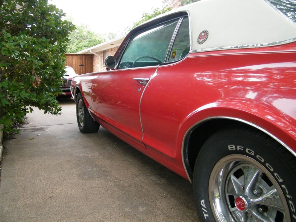 Red 1968 Mercury Cougar side view with white vinyl top