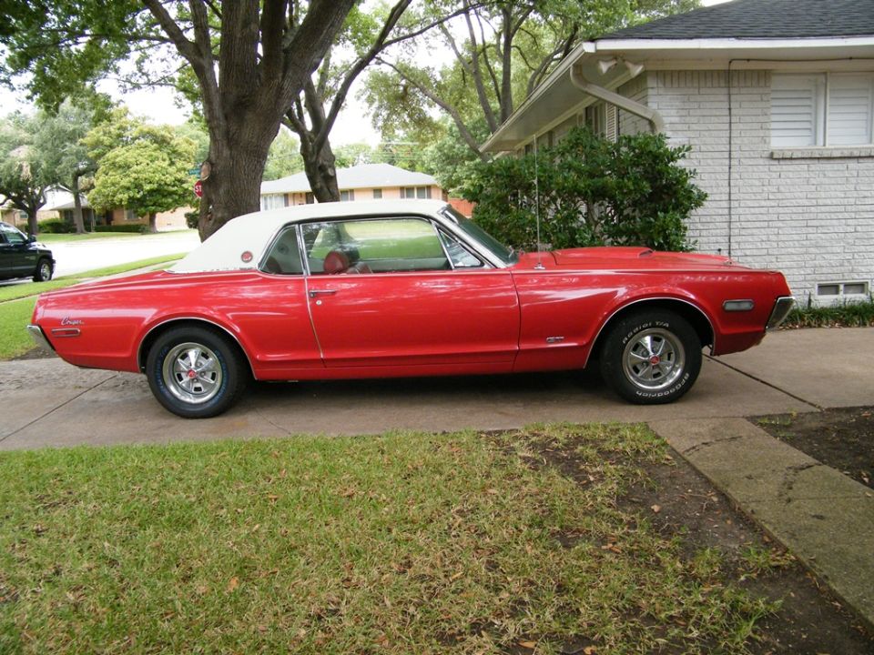 Red 1968 Mercury Cougar convertible with a white top parked on a driveway