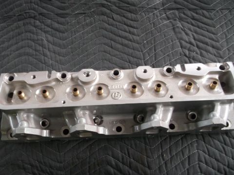 1971 Ford Ranchero - Close-up view of an aluminum engine cylinder head, brass inserts for valve guides.