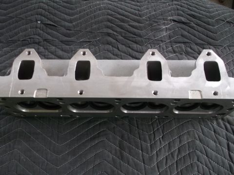 1971 Ford Ranchero - Close-up of an engine cylinder head, showing intake ports and bolt holes.
