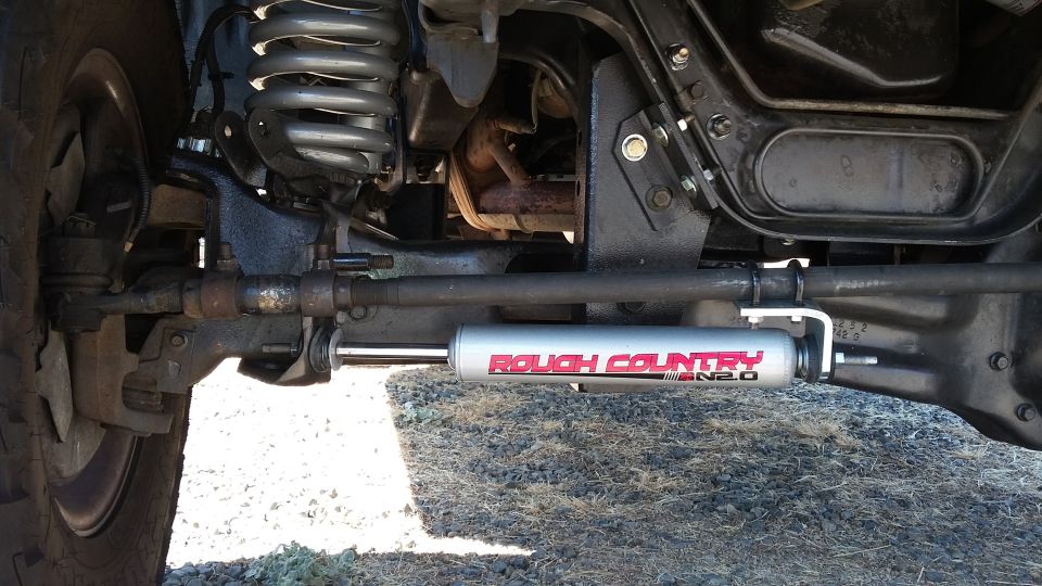 Steering stabilizer with 'Rough Country N2.0' text mounted on vehicle suspension