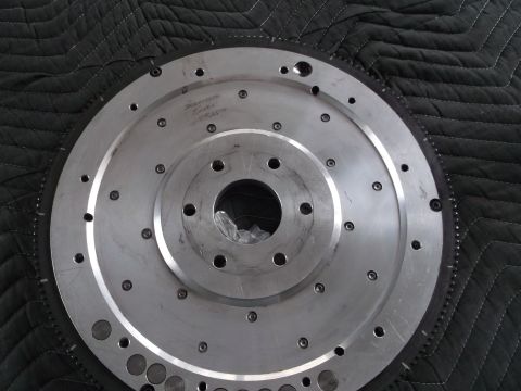 1971 Ford Ranchero - A metal flywheel, possibly for a Ford Ranchero, is shown with visible bolt holes and engraved text.