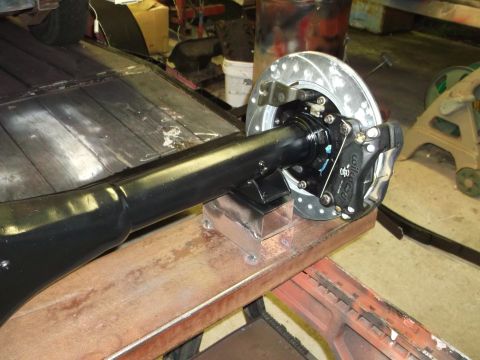 1967 Ford Mustang - Close-up of a rear axle assembly a disc brake system, likely undergoing restoration or modification.