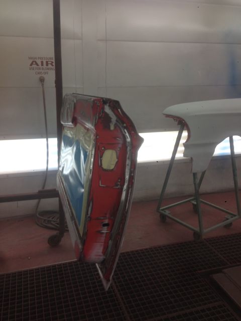 1964 Ford Fairlane - A car door and fender are in a paint booth, ready for refinishing.