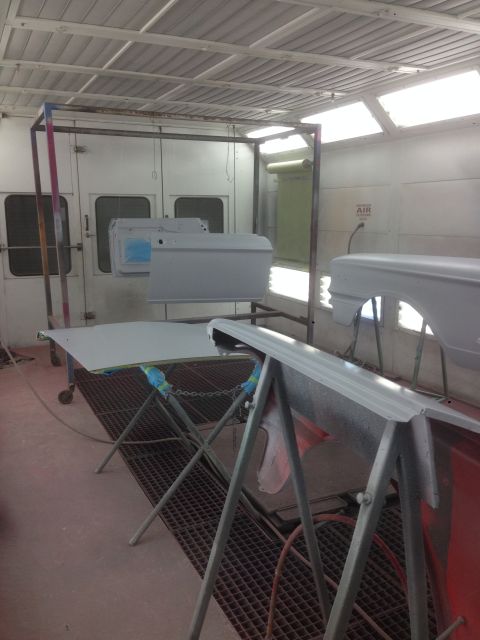1964 Ford Fairlane - Car body panels are prepped and primed inside a professional paint booth.