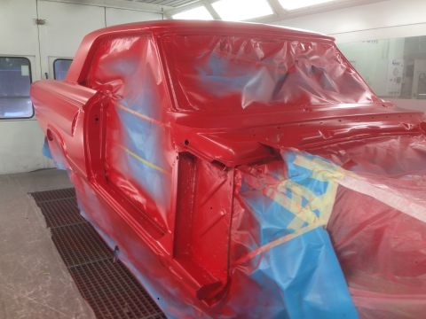 1964 Ford Fairlane - A red 1964 Ford Fairlane coupe is being prepped for painting inside a spray booth.