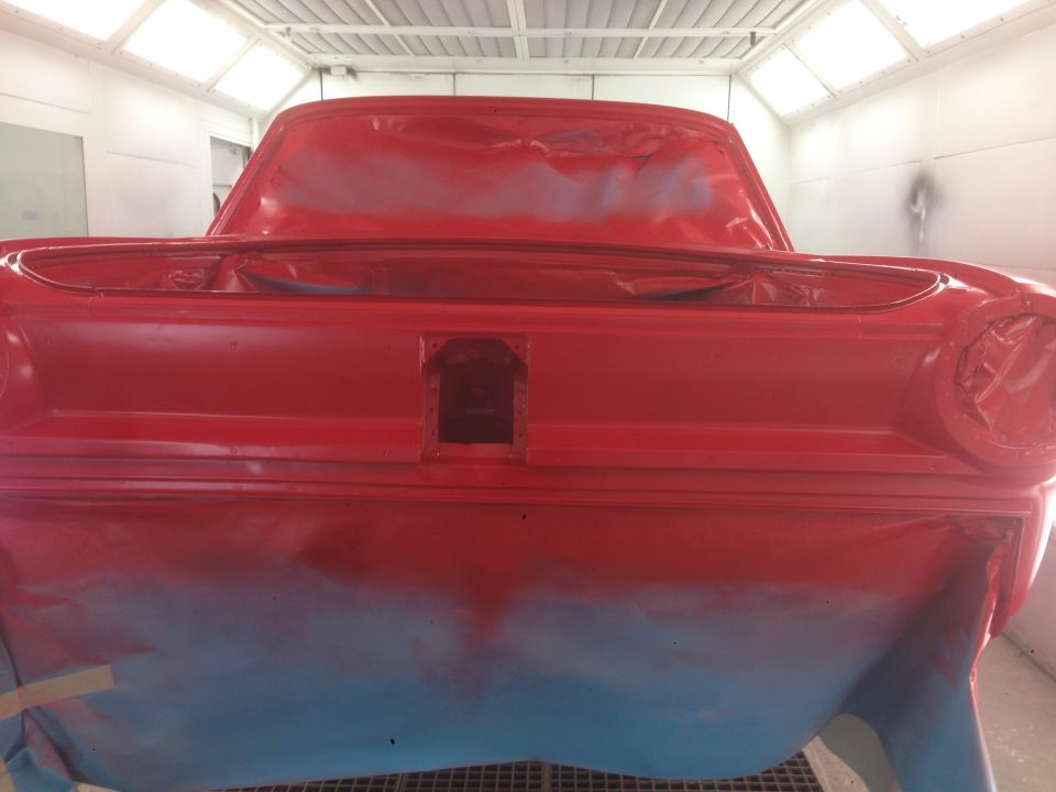 Red 1964 Ford Fairlane rear in paint booth