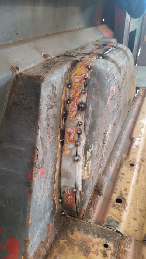 1979 Ford Bronco - This photo shows a section of a vehicle undergoing repair with visible welding work on a metal panel.
