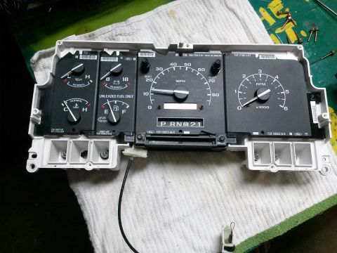 1996 Ford Bronco - Instrument cluster from a 1996 Ford Bronco, showing gauges and digital odometer display.