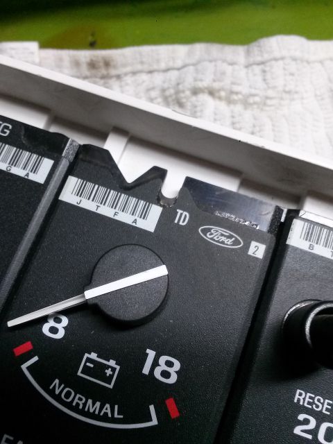 1996 Ford Bronco - This close-up shows a Ford instrument cluster, a battery gauge and part numbers.