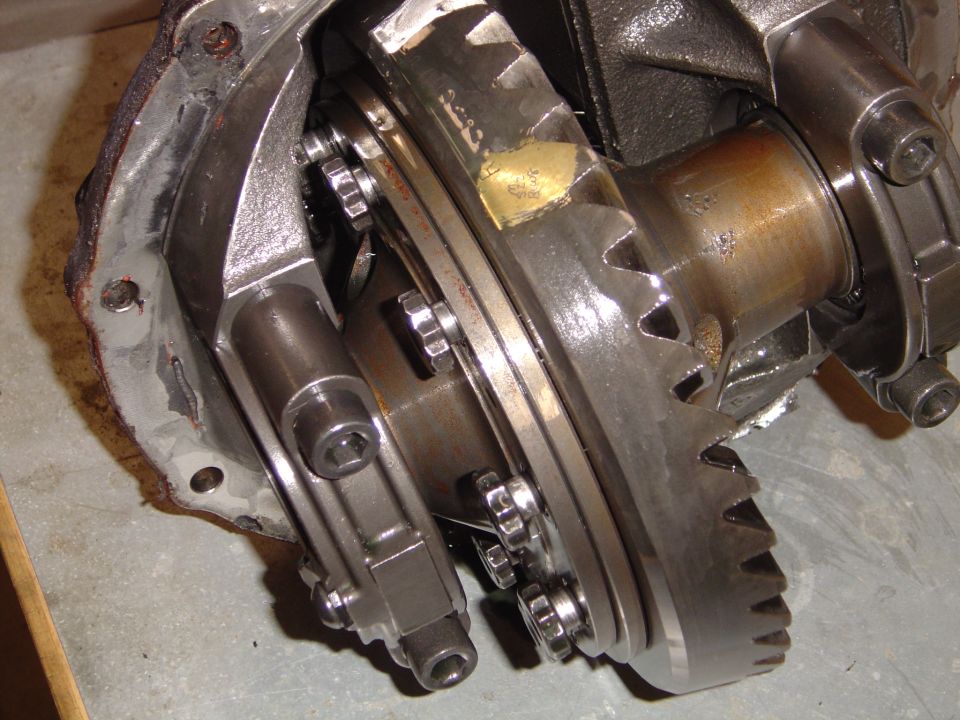 Differential gears with visible wear and a patch repair on a metal component