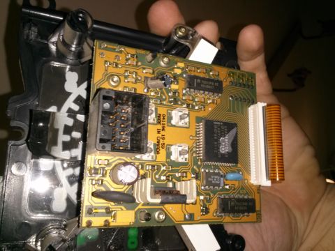1996 Ford Bronco - A circuit board with visible text and components is held in a hand.