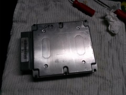 1996 Ford Bronco - An engine control module is shown, with an arrow and 'UP' written on its metal casing.