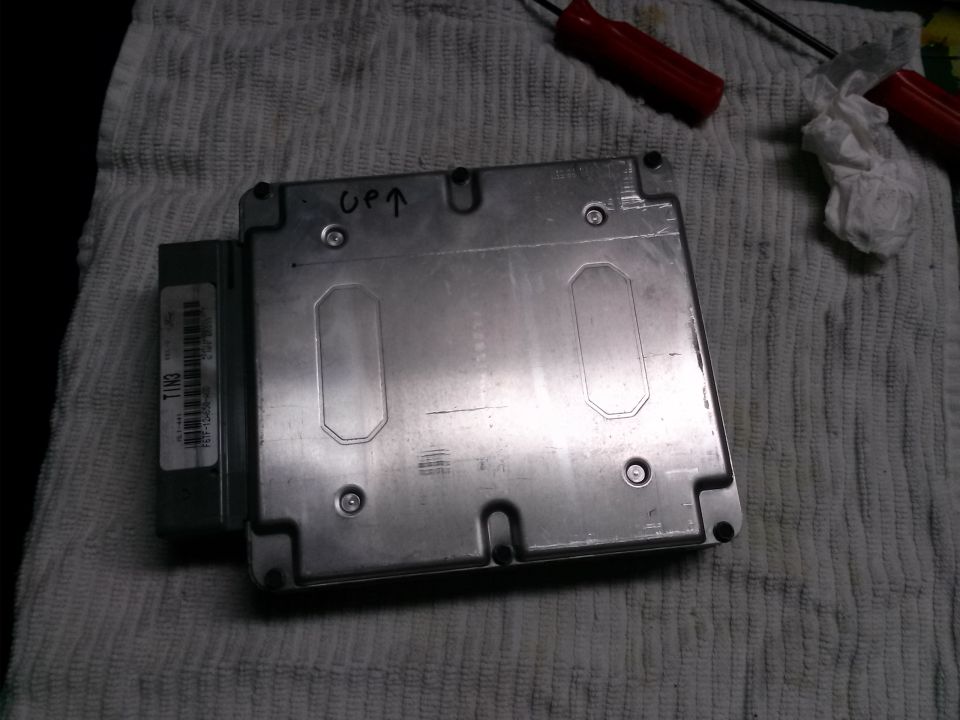 Engine control module with 'UP' written on it