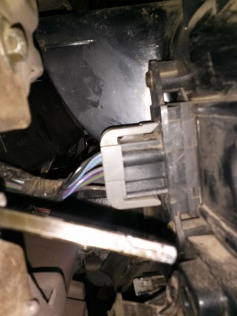 1996 Ford Bronco - A close-up view of a vehicle's interior wiring harness connector.