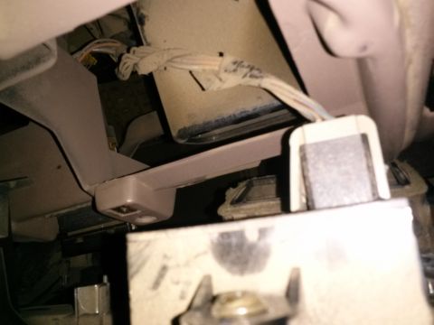 1996 Ford Bronco - Close-up view of interior wiring and plastic trim components, likely part of a dashboard or console.
