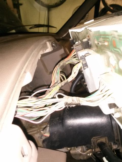 1996 Ford Bronco - Tangled wiring harness visible under the dashboard of a vehicle.