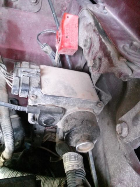 1996 Ford Bronco - Engine bay components are visible, including a red electrical connector and a complex wiring harness.