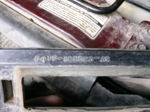 1996 Ford Bronco - Embossed part number F4TF-12B523-AC is visible on a black plastic component.