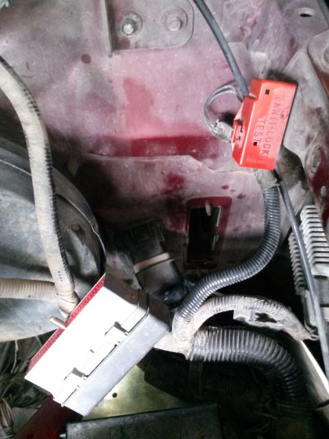 1996 Ford Bronco - Engine bay wiring and components, including a red ABS test connector and a fuse box.