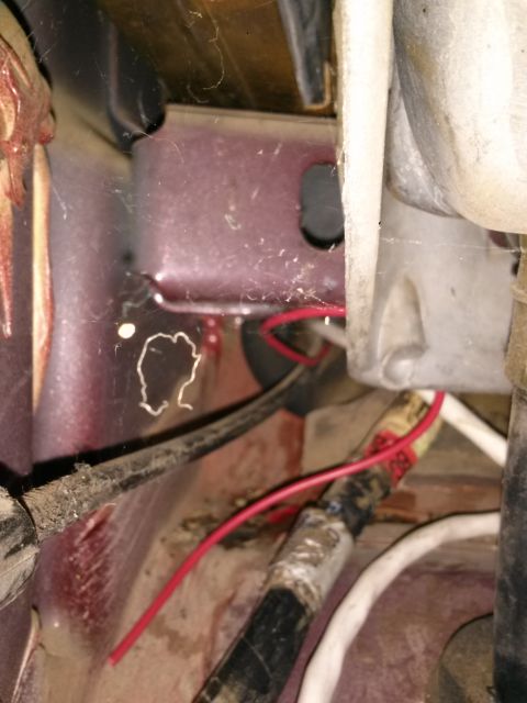 1996 Ford Bronco - Detail of wiring and structural components within a vehicle, showing signs of age and dust.