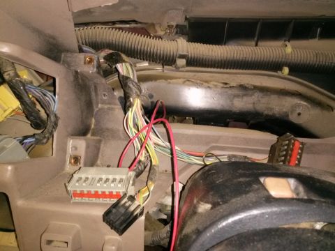 1996 Ford Bronco - Close-up view of a vehicle's interior dashboard wiring harness, showing various colored wires and connectors.