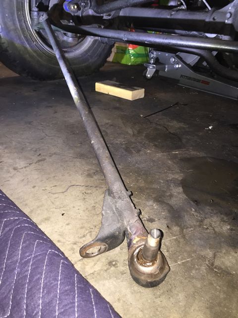 1978 Ford Bronco - Close-up of a tie rod end and drag link assembly, likely removed for repair or replacement.